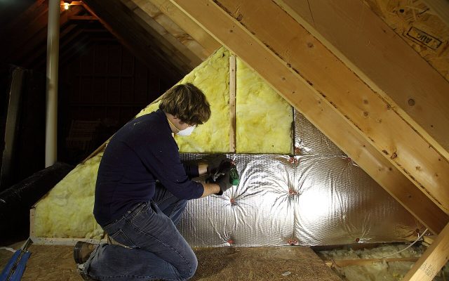 Worker inspecting an attic