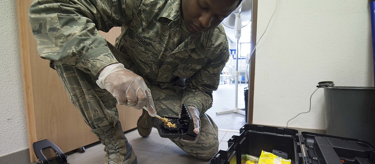 Pest management technician setting a rodent trap