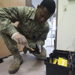 Pest management technician setting a rodent trap