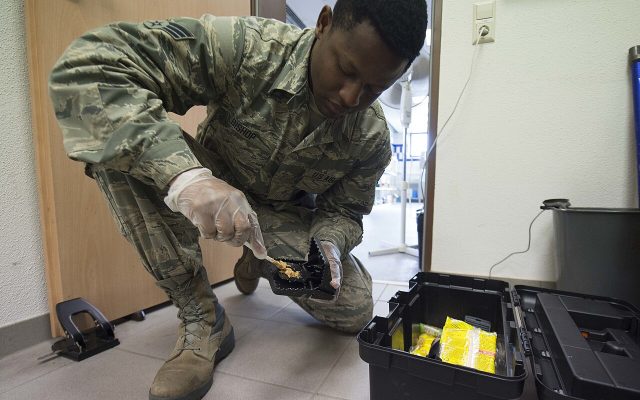 Pest management technician setting a rodent trap